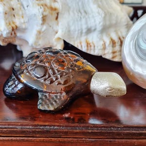 Vintage amber colour turtle shaped perfume bottle.