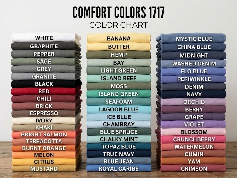 May include: Color chart displaying stacks of folded t-shirts in various colors, including white, black, red, and blue. The text "COMFORT COLORS 1717 COLOR CHART" is at the top, with color names like "Graphite" and "Mustard" listed.
