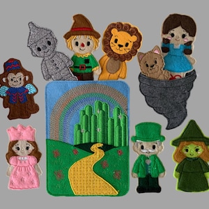 May include: A set of felt finger puppets featuring characters and a scene from The Wizard of Oz, including a tin person, scarecrow, lion, monkey, dog, girl, princess, man in a green hat, and green witch, alongside a rectangular felt backdrop.