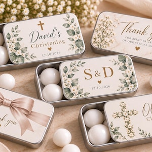 May include: Five rectangular metal sliding tins filled with white round sweets. The lids feature floral designs, crosses, and text including David's Christening, Thank you, S & D, and Olivia's Christening, all dated 12.10.2026 with small heart icons.