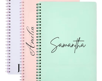 May include: Three spiral-bound notebooks in pastel shades: lavender, peach, and mint green. The mint green notebook has the name "Samantha" in black script. The peach notebook has the name "Amelia" in black script. The lavender notebook has the letter "J" in black script. The text "Style 1" is at the bottom.