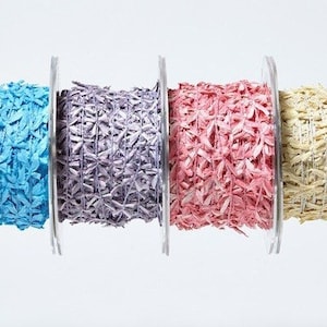 May include: Six spools of curling ribbon in various colors, including green, blue, purple, pink, yellow, and white. The ribbon is made of shredded paper and is perfect for adding a touch of whimsy to gifts and crafts.