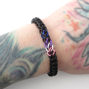 Genderfluid pride flag bracelet in the half Persian 3 in 1 chainmail weave shown on a wrist with a white background