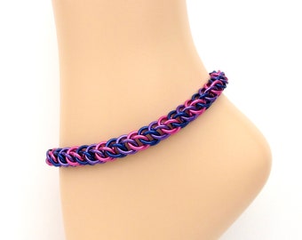 May include: A purple and pink chainmail anklet. The anklet is made of small metal rings that are linked together in a pattern.