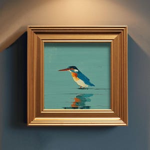 May include: A framed painting of a kingfisher bird. The bird has blue, orange, and white feathers, a long red beak, and is standing in water. The painting is in a gold-colored wooden frame.