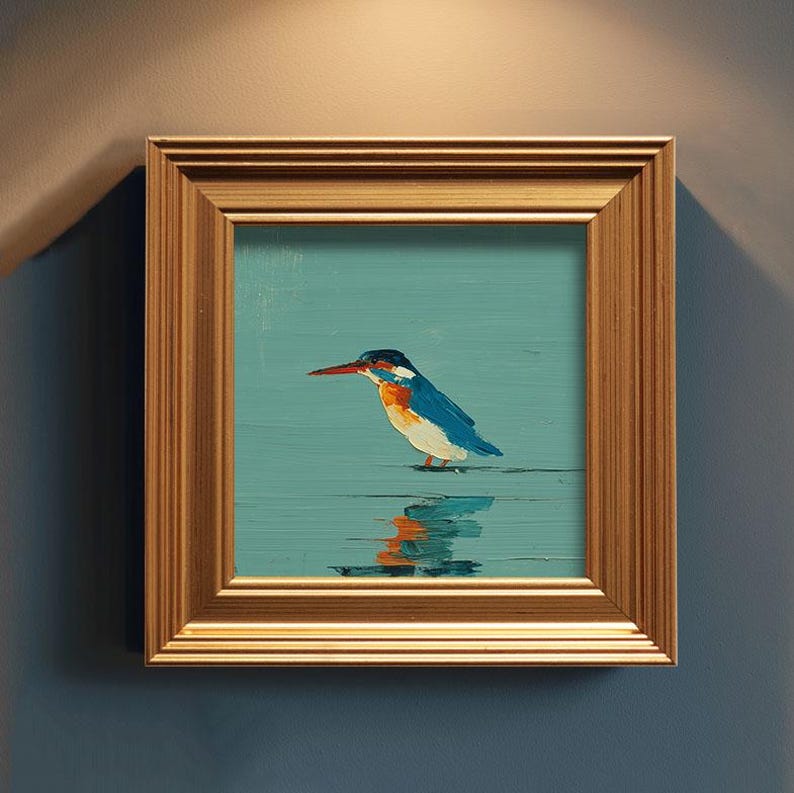 May include: A framed painting of a kingfisher bird. The bird has blue, orange, and white feathers, a long red beak, and is standing in water. The painting is in a gold-colored wooden frame.