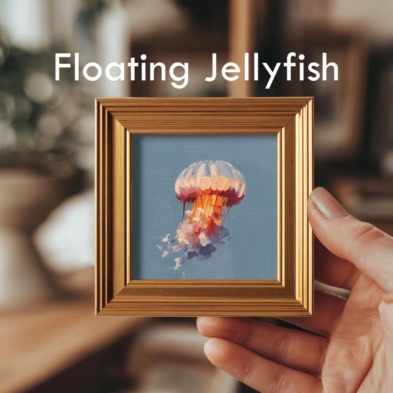 May include: A framed painting of a jellyfish with the text "Floating Jellyfish". The artwork features a jellyfish with a pink and orange bell and trailing tentacles against a blue background, set within a gold frame.