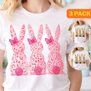 May include: White t-shirt featuring a graphic of three pink bunny rabbits with leopard print patterns, pink bows, and round tails. The image includes a "3 PACK" label in the upper right corner, and two smaller images of the shirt.