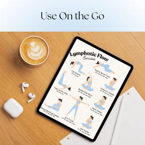 May include: A digital tablet displays "Lymphatic Flow Exercises" with illustrations of various stretches. A cup of coffee with latte art, wireless earbuds, and a charging case are on a wooden surface.