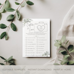 May include: A white wedding game card with the text "Capture the Love" and a camera graphic. The card includes a list of photo prompts and the text "Editable Template. Instant Download. Print at Home."