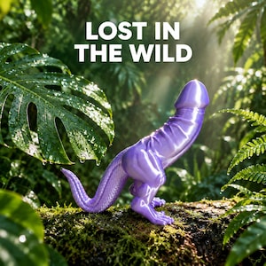 Peut inclure: Une figurine en forme de dinosaure violet brillant avec une tête phallique et une queue texturée, posée sur une bûche moussue. Le texte LOST IN THE WILD est imprimé en lettres capitales blanches au-dessus de l'objet, dans une jungle.