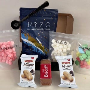 May include: A set of three ceramic mugs with a speckled, matte finish. The mugs are in shades of cream, light gray, and dark gray. Each mug has a simple, minimalist design, perfect for coffee or tea.