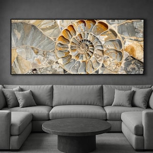 May include: A framed wall art print featuring a detailed close-up of a fossilized ammonite shell. The artwork showcases the spiral pattern in shades of gray, brown, and gold, creating a natural and textured appearance. The print is displayed above a gray sectional sofa.