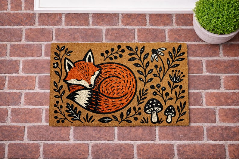 A decorative door mat with a fox curled up and surrounded by various plants and mushrooms.