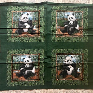 May include: Green fabric panel with four panda bear illustrations in bamboo frames. The pandas are black and white, some holding bamboo. The fabric has a border with panda bear silhouettes.