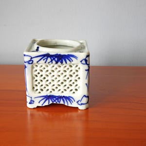 May include: A set of three ceramic mugs with a speckled, matte finish. The mugs are in cream, light grey, and dark grey. Each mug has a simple, minimalist design, ideal for coffee or tea.