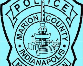 May include: A black and light blue police badge featuring the text "POLICE MARION COUNTY INDIANAPOLIS METROPOLITAN". The badge has a central design of a monument with a flame at the top.