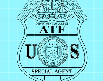 May include: A black and white graphic of a shield-shaped badge with an eagle at the top. The badge reads "DEPARTMENT OF JUSTICE ATF" and "U.S." with text around a central emblem. The words "SPECIAL AGENT" are at the bottom.