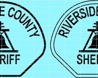 May include: Two black and white Riverside County Sheriff badges. The badges feature the words "Riverside County" in a semi-circle at the top, with a bell and cross design in the center, and the word "Sheriff" at the bottom.