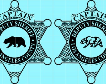 May include: Two black and white Los Angeles County Deputy Sheriff badges with a star shape and the words "CAPTAIN" and "DEPUTY SHERIFF" at the top. The words "LOS ANGELES COUNTY" are at the bottom. A bear is in the center.