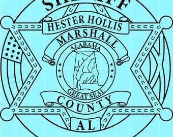 May include: A black and white Sheriff badge design with the text "SHERIFF", "HESTER HOLLIS MARSHALL ALABAMA", "GREAT SEAL COUNTY AL". The badge features a star shape with an American flag and a map of Alabama.