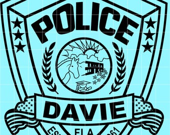 May include: Black and white Davie Police badge design on a light blue background. The badge features the word "POLICE" at the top, "DAVIE" in the center, and the text "EST.1925" and "INC.1961" at the bottom. The badge also includes stars, an illustration, and American flags.