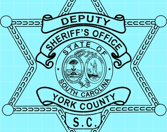 May include: A black and white Deputy Sheriff's badge from York County, South Carolina. The badge is a six-pointed star with the words "Deputy", "Sheriff's Office", "State of South Carolina", and "York County" displayed.