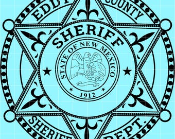 May include: Black and white Eddy County Sheriff Dept. badge design. The design features a six-pointed star with the words "Eddy County Sheriff Dept." and "State of New Mexico" encircling a central emblem with an eagle and the year 1912.
