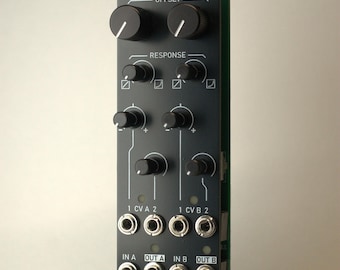 May include: A black electronic module with the text "GALĒNĒ" and "OFFSET" at the top. It has several knobs and input/output jacks. The text "RESPONSE", "1 CVA 2", "1 CV B 2", "IN A", "OUT A", "IN B", and "OUT B" are also visible.