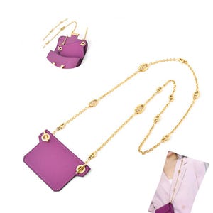 May include: A purple leather pouch with a rectangular shape and a gold-toned chain strap. The chain features repeating oval-shaped links and attaches to the pouch with gold-toned hardware. The pouch has a smooth texture and visible stitching.