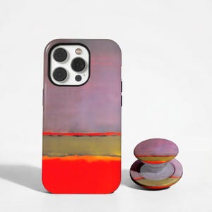 Könnte beinhalten: Eine rechteckige Smartphone-Hülle und ein passender runder, ausziehbarer Handyhalter. Das Design zeigt horizontale Farbbänder, darunter einen großen violetten Bereich oben, eine dünne rote Linie, einen olivgrünen Streifen und eine leuchtend rote Basis.