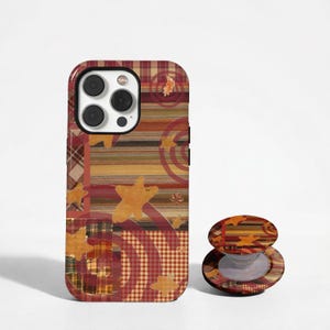 May include: A smartphone case and a matching collapsible phone grip featuring a warm-toned pattern of red, brown, and tan plaid, horizontal stripes, and gingham checks, accented with scattered yellow star shapes and circular red line motifs.