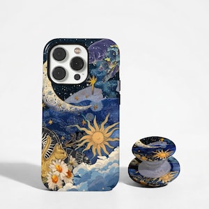May include: A smartphone case and a matching circular phone grip featuring a dark blue celestial design with a golden sun, a crescent moon, a cat, white daisies, and swirling clouds against a starry night sky background.