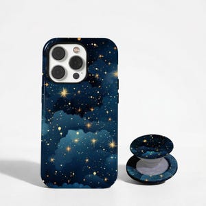 May include: A dark blue iPhone case and matching phone grip with a starry night design, featuring gold stars and cloud-like shapes. The case has a glossy finish and a camera cutout.