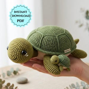 May include: A green crochet turtle and baby turtle, handmade with a textured shell and smiling face. The image includes a blue and white graphic that says "INSTANT DOWNLOAD PDF".