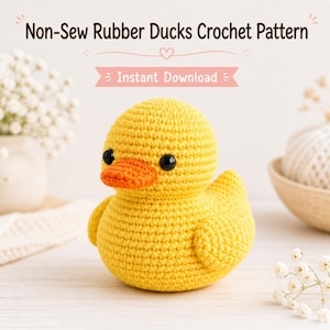 May include: A yellow crochet rubber duck with an orange beak and black eyes. The duck is on a white surface. The text "Non-Sew Rubber Ducks Crochet Pattern" and "Instant Download" are visible.
