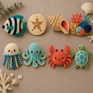 May include: A collection of crocheted sea creatures including a striped fish, a sand dollar, a spiral shell, a coral reef piece, a jellyfish with curly tentacles, an octopus, a red crab, and a sea turtle, arranged on a neutral fabric surface.
