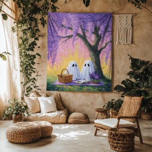 May include: A rectangular wall tapestry featuring a painting of two white ghosts sitting under a large tree with purple wisteria flowers. The ghosts are on a purple blanket with a woven picnic basket and an open book on the grass.