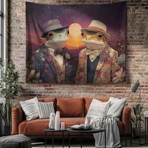 May include: A large tapestry depicting two frog characters in suits and hats, set against a sunset. The frogs are wearing floral suits, bow ties, and fedoras. The background features a large sun, mountains, and a starry sky.