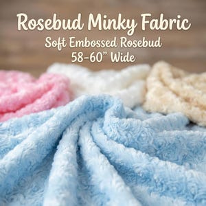 May include: Soft, embossed Rosebud Minky fabric in various colors, including pink, white, blue, and beige. The fabric is 58-60 inches wide. The image features the text "Rosebud Minky Fabric" and "Soft Embossed Rosebud 58-60" Wide."