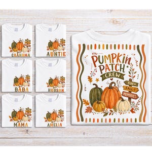 May include: A collection of white t-shirts featuring a graphic of three pumpkins in green, orange, and cream, surrounded by autumn leaves and a wooden signpost with the text "FUN FALL MEMORIES". The large central shirt displays the text "PUMPKIN PATCH CREW" in brown and orange lettering, while the smaller shirts include personalized names like "GRANDMA", "AUNTIE", "DADA", "HUDSON", "MAMA", and "AMELIA".