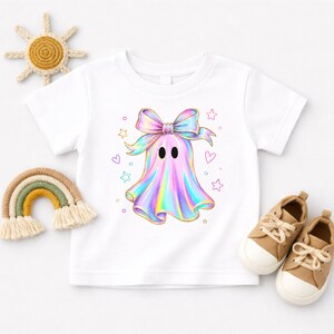 Cute holographic pastel ghost with a bow surrounded by stars and hearts, trendy toddler girls halloween shirt design.