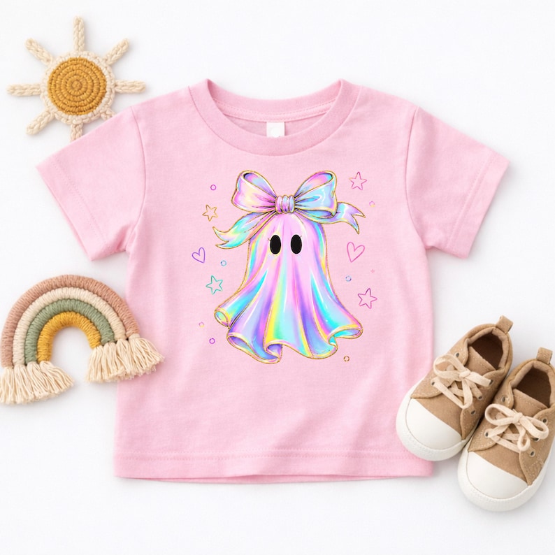 Cute holographic pastel ghost with a bow surrounded by stars and hearts, trendy toddler girls halloween shirt design.