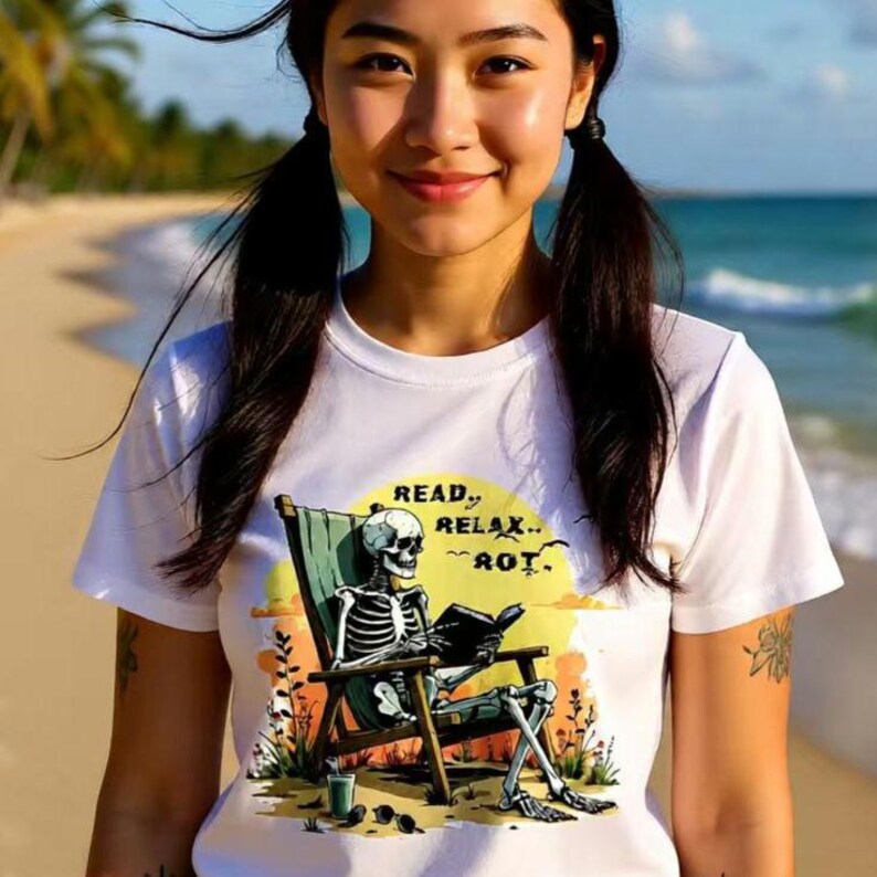 Grunge bookish t-shirt with a illustrated skeleton reading on a beach chair at sunset perfect gothic reader gift on white tee