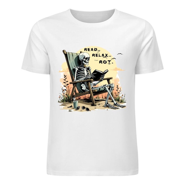 White t-shirt featuring a skeleton relaxing in a beach chair reading a book with the text Read Relax Rot in a warm sunset illustrated design