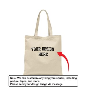 A beige tote bag with the text "YOUR DESIGN HERE" printed on it, along with a red arrow pointing to the right side of the bag.