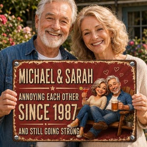 May include: A rectangular metal sign with a distressed red background featuring the text "MICHAEL & SARAH ANNOYING EACH OTHER SINCE 1987 AND STILL GOING STRONG". The sign displays a cartoon illustration of a couple sitting on a wooden bench.