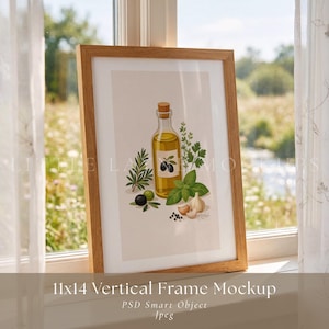 May include: A framed print featuring a still life of olive oil, olives, and herbs. The artwork includes a bottle of olive oil with a cork stopper, surrounded by olives, basil, rosemary, and garlic. The frame is a light brown color and the print is 11x14 inches.