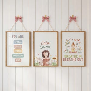 May include: Three framed art prints with positive messages and illustrations. One print reads "You Are" with encouraging words. Another says "Calm Corner" with animal characters. The third print shows a girl meditating with butterflies and the text "Breathe In Breathe Out".