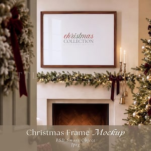 May include: A horizontal wooden picture frame hanging above a fireplace mantel, featuring a white insert with the red and gray text "christmas COLLECTION". A green garland with lights and a dark red velvet ribbon adorns the mantelpiece.
